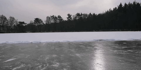 Man Slide On Frozen Lake GIF