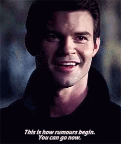 Man Smiling And Talking About Rumors GIF