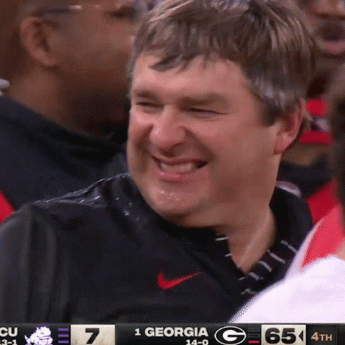 Man Smiling at Scoreboard 1 Georgia G 65 4th