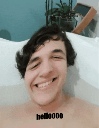 Man Smiling in Bathtub Saying Helloooo