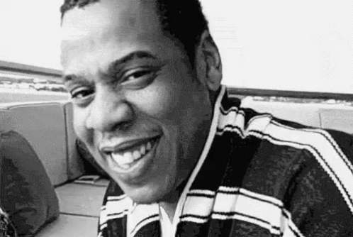 Man Smiling In Black And White On Couch GIF