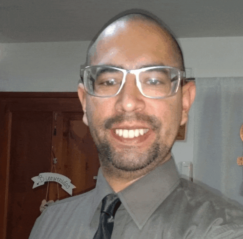 Man Smiling in Front of Bienvenidos Sign