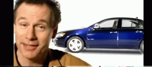 Man Smiling in Front of Blue Car