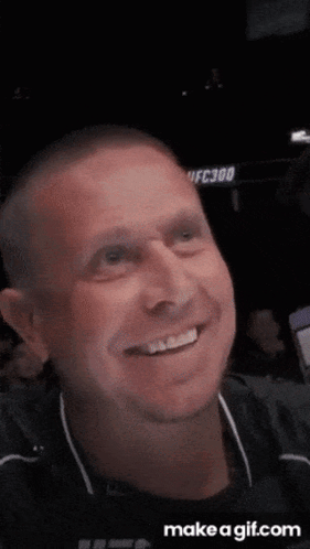 Man Smiling in Front of UFC300 Sign