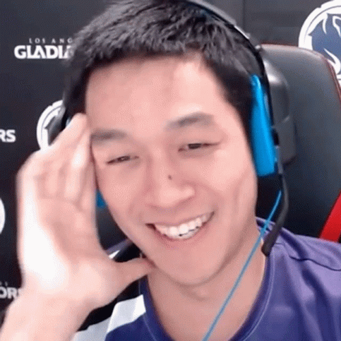 Man Smiling In Headphones At Los Angeles Gladiators Sign GIF