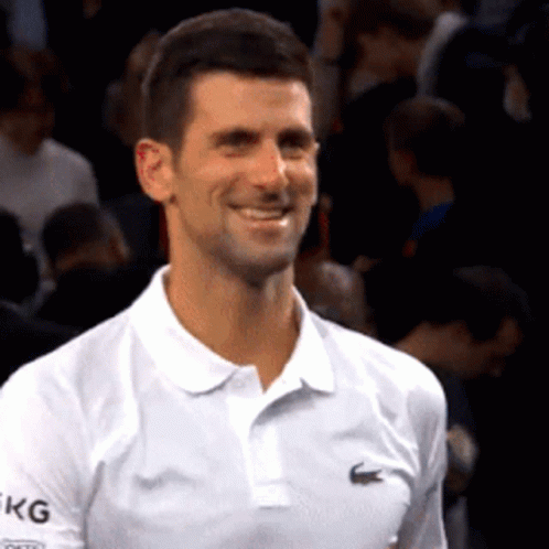 Man Smiling in White Lacoste Polo