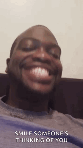Man Smiling on Couch Saying Smile Someone's Thinking of You