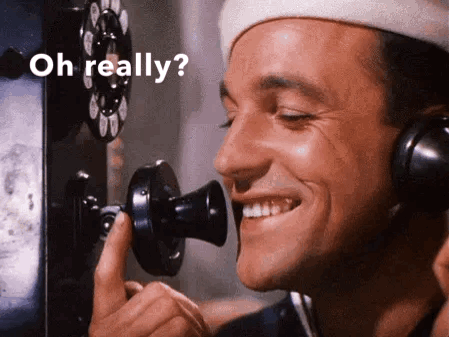 Man Smiling on Phone Saying Oh Really