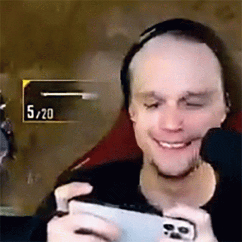 Man Smiling Playing Video Game on Cell Phone