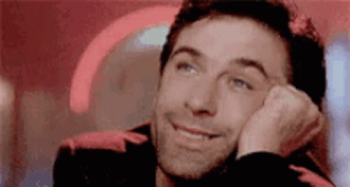 Man Smiling Resting Hand on Face