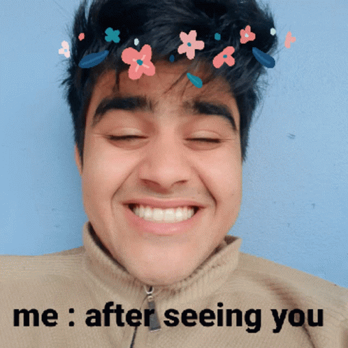 Man Smiling With Flowers in Hair Saying Me After Seeing You