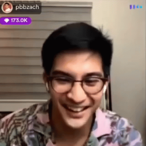 Man Smiling with Glasses and Earbuds