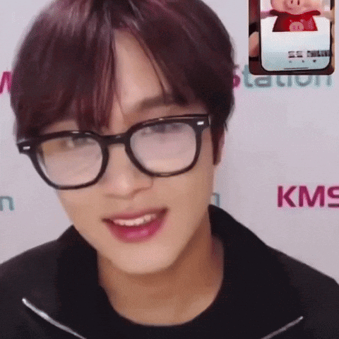 Man Smiling With Glasses Next to KMS Logo