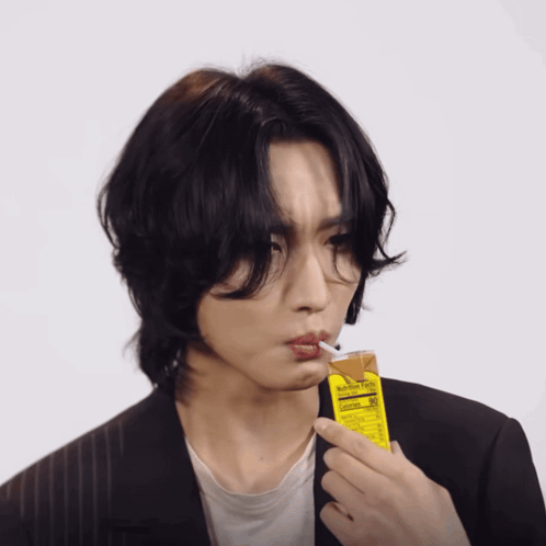 Man Smoking Cigarette Holding Juice Carton Nutrition Label