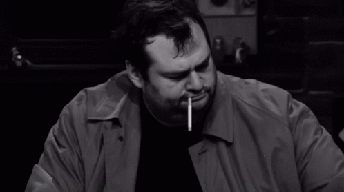 Man Smoking Cigarette Holding Paper