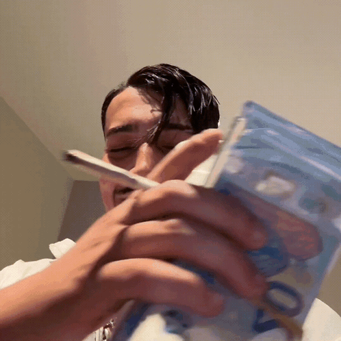 Man Smoking Cigarette Holding Stack of 20 Euro Notes
