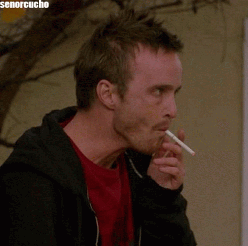 Man Smoking Cigarette In Front Of Senorcucho Sign GIF
