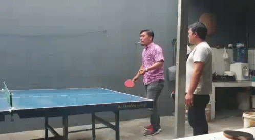 Man Smoking Cigarette Playing Ping Pong
