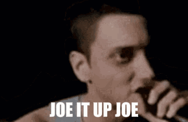 Man Smoking in Dark Room Says Joe It Up Joe