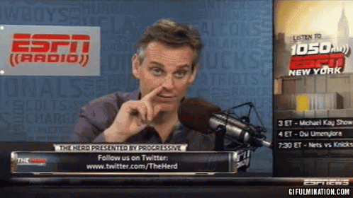 Man Speaking Into Microphone in Front of ESPN Radio Sign