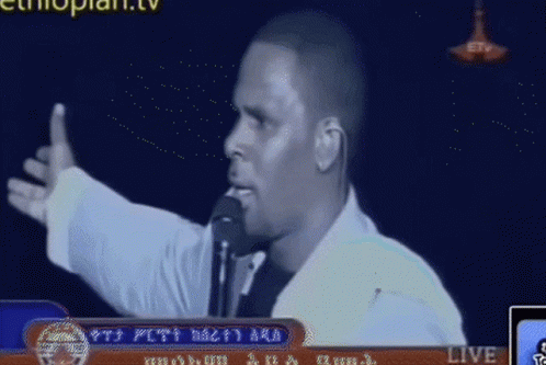 Man Speaking into Microphone on TV