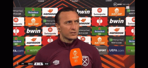 Man Speaking Into Microphone With Bwin and Swissquote