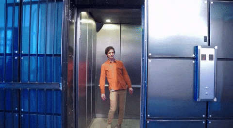 Man Spinning His Hips Inside Elevator GIF