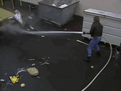 Man Splashing Water Using Fire Hose GIF