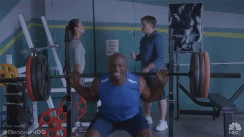 Man Squatting Barbell in Gym Brooklyn 99