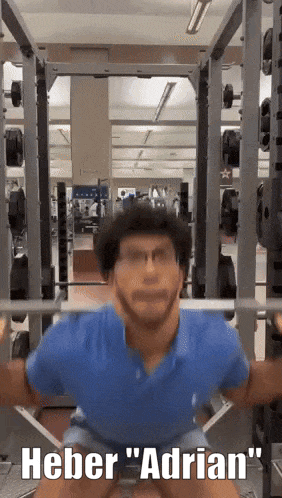 Man Squatting in Gym Saying Heber Adrian