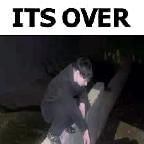 Man Squatting On Couch In Dark Room Saying It's Over GIF