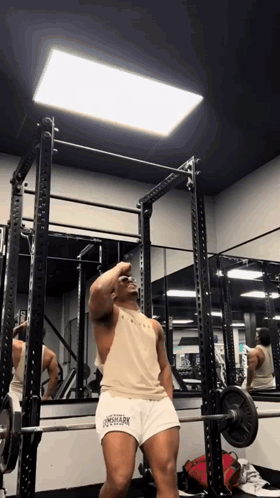 Man Squatting With Barbell in Gym Wearing Longshark Tank Top