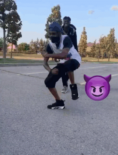 Man Squatting With Devil Emoji Behind GIF
