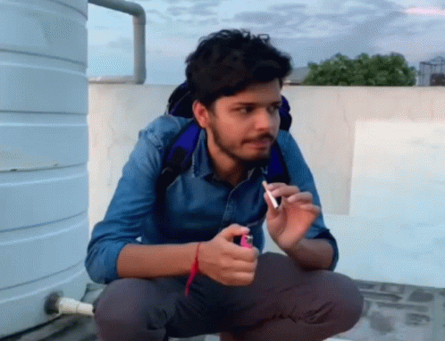 Man Squatting With Lighter and Cigarette