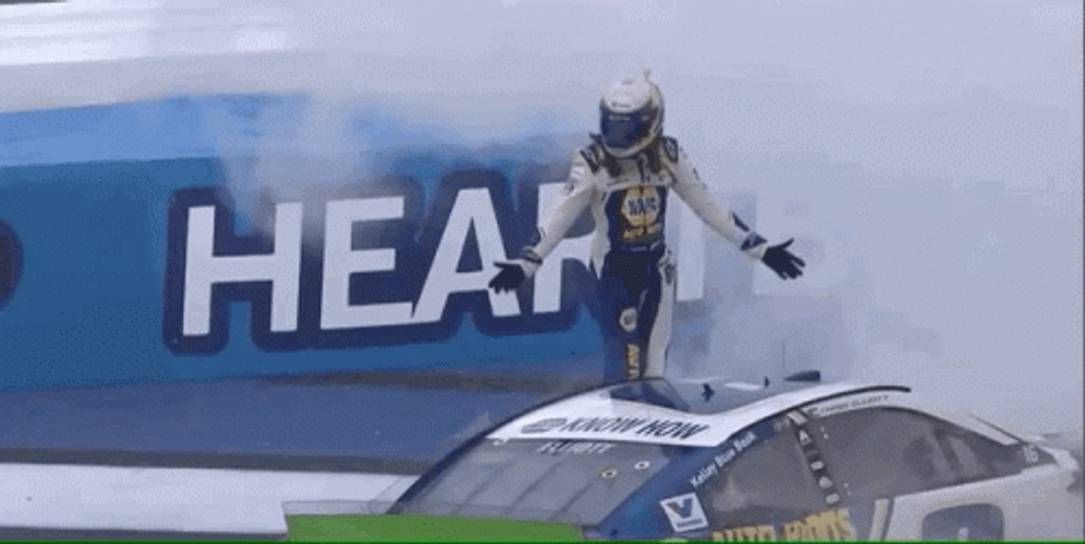 Man Standing As Winner Above Race Car GIF