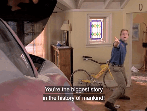 Man Standing Before Bicycle Saying You're the Biggest Story