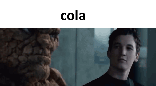 Man Standing Before Cola Statue