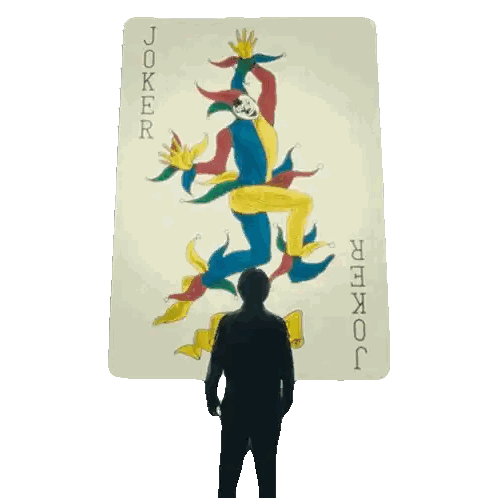 Man Standing Before Joker Card