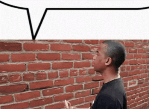 Man Standing by Brick Wall With Speech Bubble