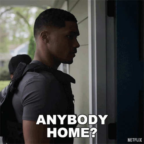 Man Standing by Door Saying Anybody Home