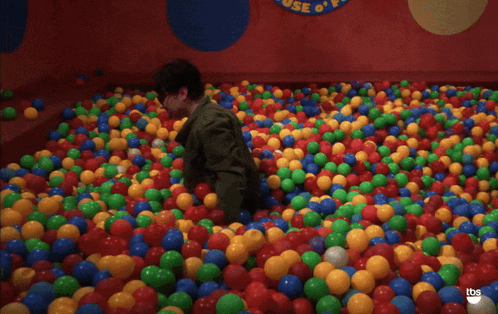 Man Standing in Ball Pit With Bazinga