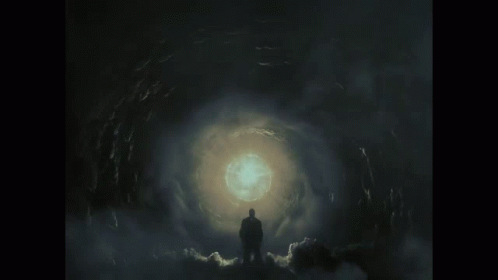 Man Standing In Dark Tunnel With Light GIF