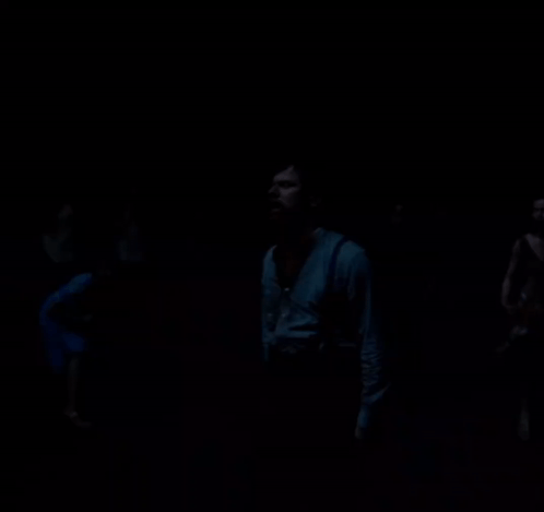 Man Standing in Darkness Looking Up