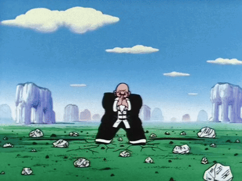 Man Standing in Field with Rocks and Mountains