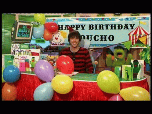 Man Standing in Front of Birthday Poncho Sign