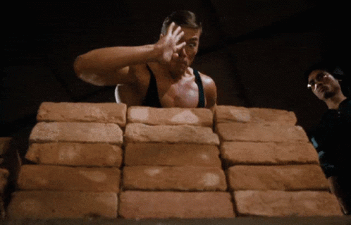Man Standing in Front of Bricks