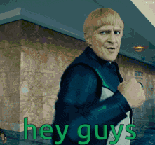 Man Standing in Front of Building Saying Hey Guys