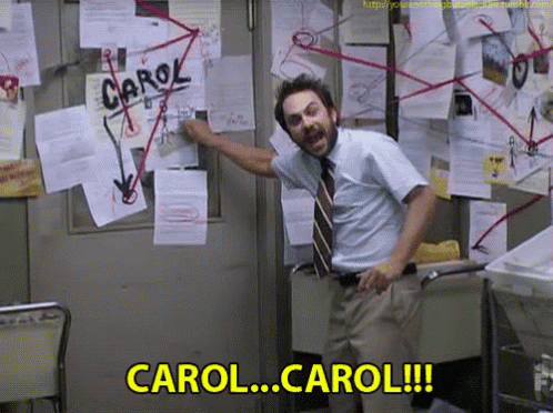 Man Standing in Front of Bulletin Board Saying Carol