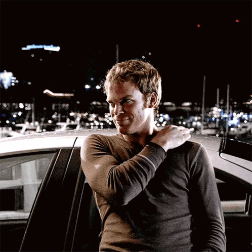 Man Standing in Front of Car with Arm on Shoulder