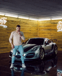 Man Standing in Front of Car with G Sign